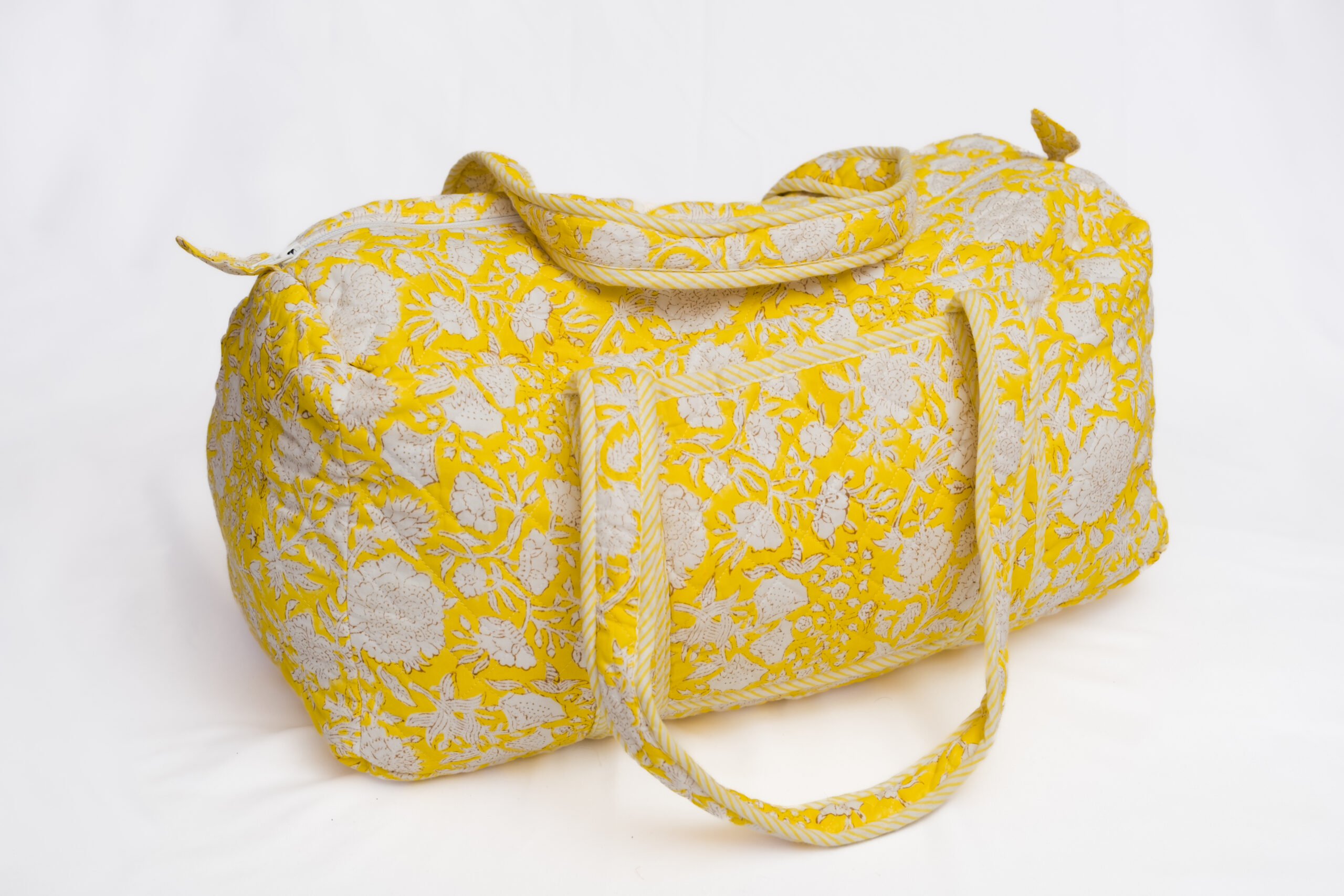 Maleta acolchada amarilla con estampado floral blanco y asas largas reforzadas