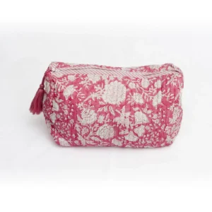 Cosmetiquera nirla fucsia con estampado floral blanco y pompón a tono